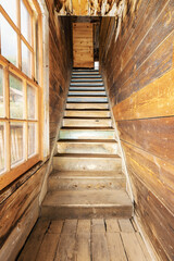 staircase inside abandoned home in colorado ghost town