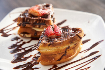    Detail shot of waffle with strawberry and chocolate     