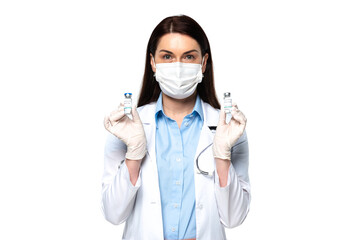 Doctor in medical mask holding jars with vaccine isolated on white