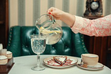 Closeup photo of female hands is reaching out to cake
