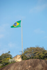 Brazil flag on top of the rudder stone in Rio de Janeiro.