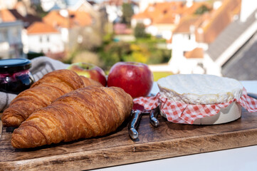 French breakfast with fresh baked croissants and cheeses from Normandy, camembert and neufchatel served outdoor with nice city view