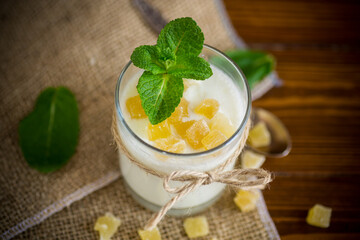 Sweet homemade yogurt with candied fruits in a glass