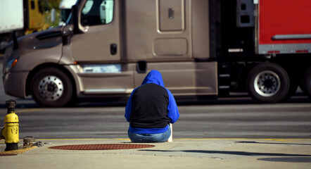 Curb Seat for Homeless Young Woman