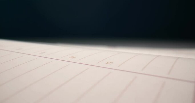 detailed extreme close-up spread of a notebook with a red bookmark.
