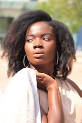 Attractive model looking at camera, close up portrait, one person, natural african model, african american model, background, outdoor portrait, looking sideways