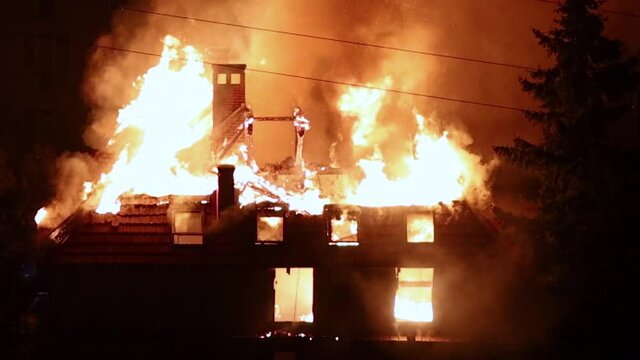 a building is on fire at night in the city