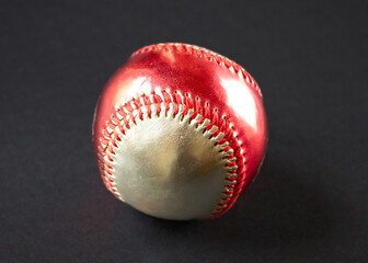 Red and silver Baseball ball isolated on black background
