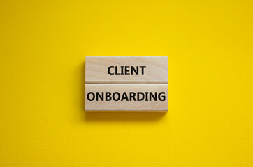 Client onboarding success symbol. Wooden blocks with words 'Client onboarding' on beautiful yellow background. Business and client onboarding success concept. Copy space.