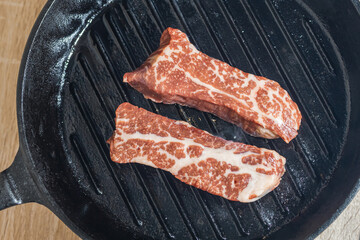 Marbled beef is fried in a grill pan. Top view, close-up
