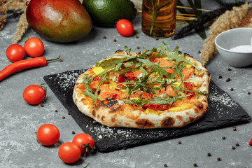 Delicious pizza with salmon and vegetables. italian pizza
