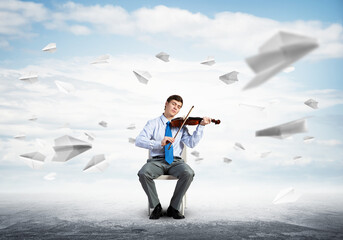 young businessman playing violin