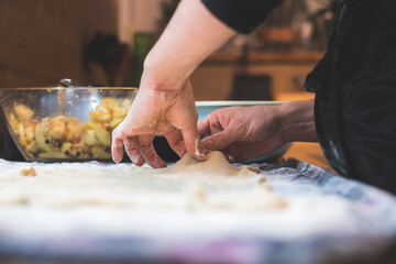 Rolling traditional dough in the kitchen, close up