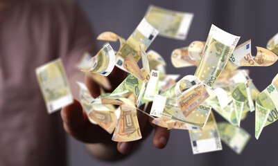 euro bills flying around  in hand
