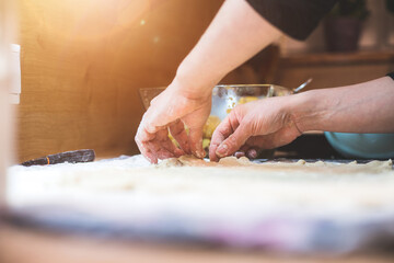Rolling traditional dough in the kitchen, close up