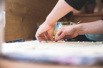 Rolling traditional dough in the kitchen, close up