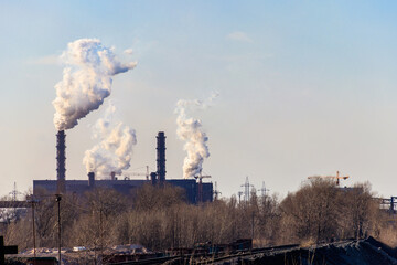 View of old factory with pipes with smoke. Air pollution, environmental damage