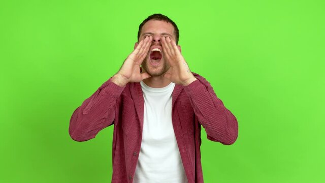 Brazilian handsome man shouting and announcing something over isolated background