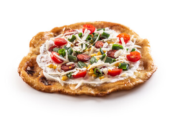 Tasty and freshly fired langos with crusty eges greased by garlic and served with, hungarian sausage, cherry chopped tomatoes, grated cheese, corn and green onion