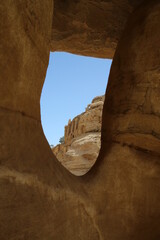 View through a window in the rock of the Obelisk Tomb in Petra