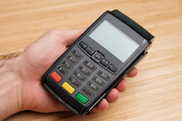 Man holding a terminal for contactless payment with copy space