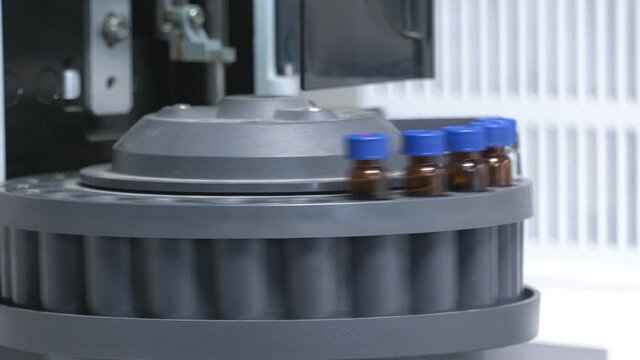 Biochemical analyzer in science laboratory. Many vials are arranged in the auto sampler for the lab equipment in chemical laboratory.

