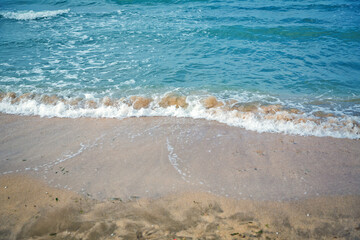 Clean and relaxing sea wave splashes over seashore. Coral beach of tropical paradise. Idyllic seascape for beach wedding or honeymoon. Exotic seaside banner . Caspian Sea sea water over white sand