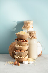 Vegan non dairy plant based milk in bottles on blue background. Alternative lactose free milk...