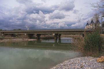 greenish river with a bridge above it