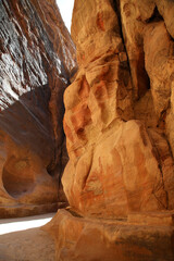 The midday lights penetrate the Siq of Petra