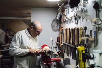 Joinery worker giving glue to a piece of wood