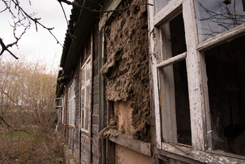 Fototapeta na wymiar An old abandoned house with broken windows. Destruction concept. Broken glass and mess
