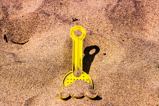 A child's yellow plastic toy shovel found on Toronto's Woodbine Beach.