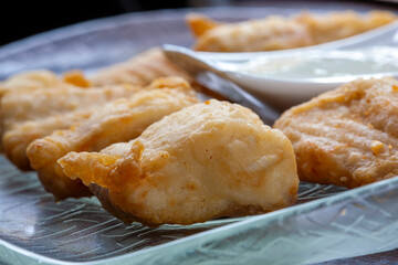 Breaded fish fillet with sauce