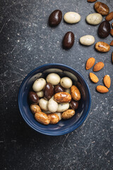 Sweet chocolate almonds. Chocolate eggs in bowl.