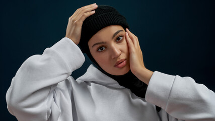 Portrait of young arab girl with hands near face