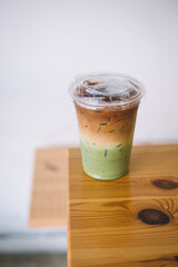 Iced matcha green tea latte coffee on wooden table