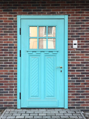 Beautiful blue door in a brick wall