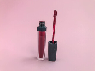 Red matte liquid lipgloss on the same bold vivid colored background. Copyspace