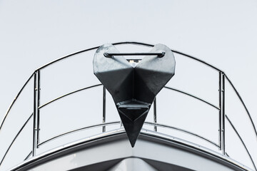 The bow of the yacht has a stainless steel rail and an anchor fixed to the bow.