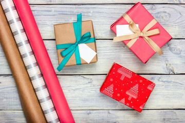 Gift boxes and wrapping paper on the table. Gift wrapping process.