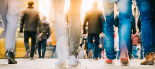 Crowd of people walking in motion in downtown rush hour
