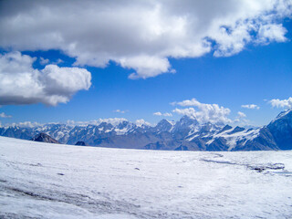 Fototapeta na wymiar Panorama of snowy mountains with clouds