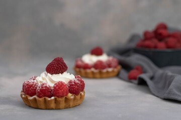 A delicious dessert for the whole family and easy diet, raspberry basket of unleavened dough with a gentle sprinkle with powdered sugar.