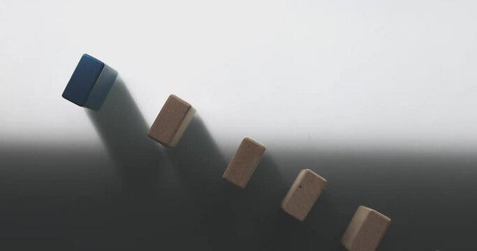 4K Video slow motion close up hand stop domino effect. business concept of try to stop the domino effect .