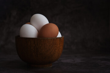white and brown chicken eggs in the bowl