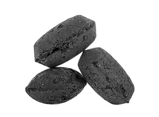 Coal briquette for BBQ isolated on a white background. Three black charcoal briquettes.