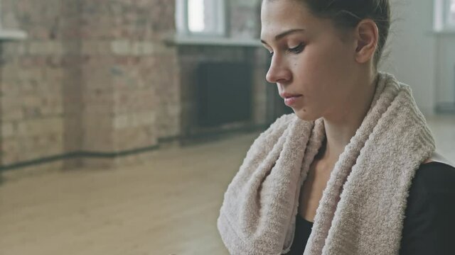 Medium Close Up Of Exhausted Young Ballerina Wiping Sweat From Forehead After Hard Indoor Ballet Training In Dance School