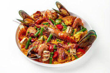 Paella. Spanish dish of rice and seafood, vegetables and chicken. Shrimp, octopus, crab and mussels. Banquet festive dishes. Gourmet restaurant menu. White background.