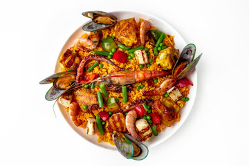 Paella. Spanish dish of rice and seafood, vegetables and chicken. Shrimp, octopus, crab and mussels. Banquet festive dishes. Gourmet restaurant menu. White background.
